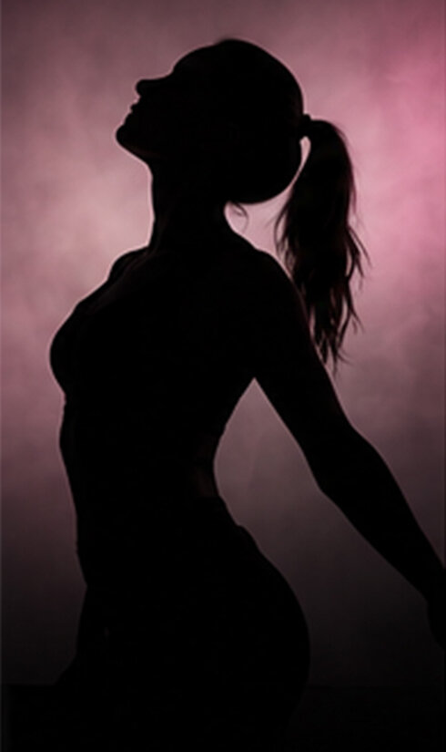 Trainerin als dunkle Silhoute im Profil.